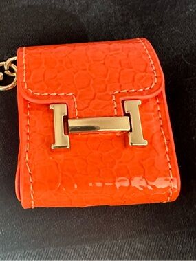 Orange ear bud holder keychain with Gold H Accent. New
